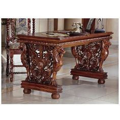 an ornate wooden table and chairs in a room