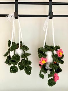 two crocheted plants hanging from hooks