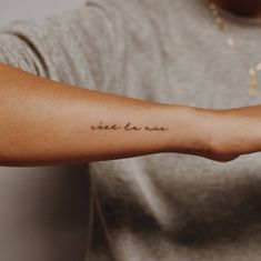 a person with a tattoo on their arm that reads, sister you in cursive writing