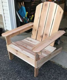 a wooden chair sitting in front of a garage