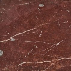 a red marble textured surface with white lines on the top and bottom, as well as dark brown veining