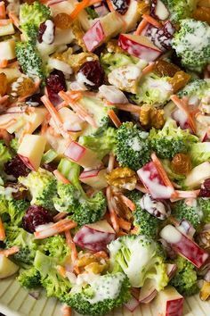 a salad with broccoli, cranberries and other vegetables