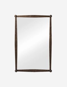 a wooden frame mirror on a white wall