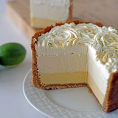 two pieces of cheesecake on a plate with limes