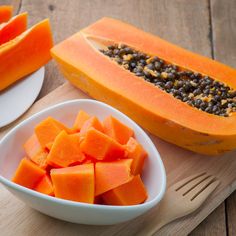 papaya slices and other fruits on a plate