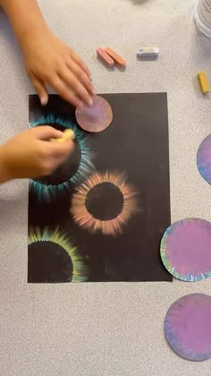 a person is making art with colored paper