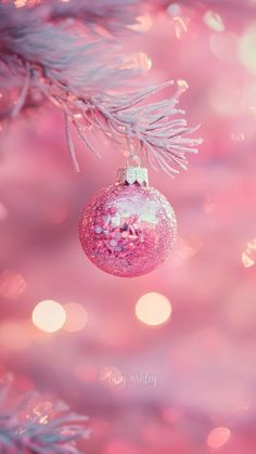 a pink ornament hanging from a christmas tree