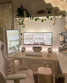 a computer desk with two monitors and a stuffed animal on it's chair in front of the monitor