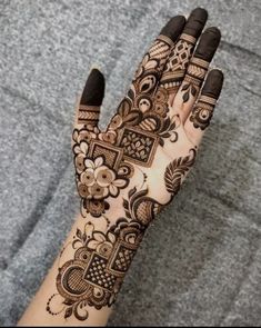 a woman's hand with hennap on it, showing the intricate design