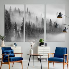 two paintings are hanging on the wall in a living room with chairs and a table