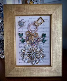 a frame with some jewelry on top of it