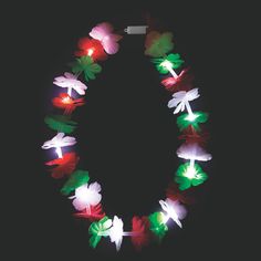 a wreath made out of paper flowers on a black background with the word love spelled in red, white and green