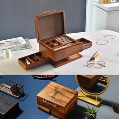 an open wooden box sitting on top of a table next to other boxes and glasses