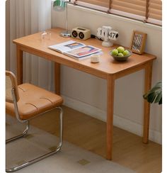 a wooden table with a bowl of fruit on top of it next to a window