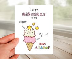 someone holding up a birthday card with an ice cream cone