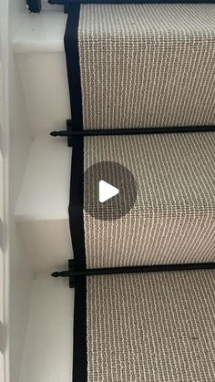 a carpeted stair tread with black rails