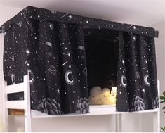 there is a black and white curtain with stars in the night sky on top of it