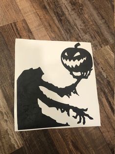 a paper cut out of a person holding a jack o lantern