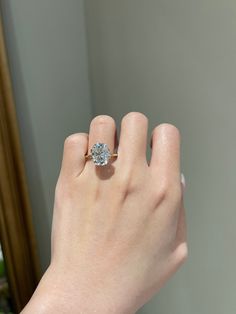 a woman's hand with a diamond ring on it