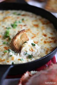 a skillet filled with cheesy bread and broccoli on the side