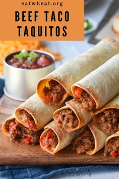 beef taco burritos on a cutting board with salsa in the background