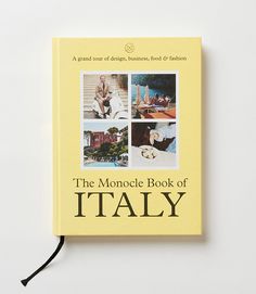 the monocle book of italy is displayed on a white surface with a black cord