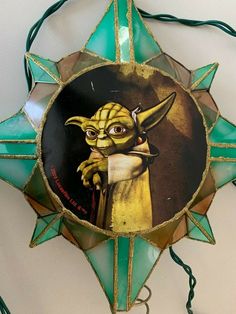 a star decoration with an image of the child yoda on it's face