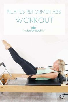 a woman is doing pilates on a bench