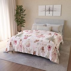 a bedroom with a large bed covered in pink and white bedspread, two paintings on the wall