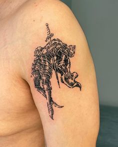 a man with a tattoo on his arm holding a knife and an elephant's head