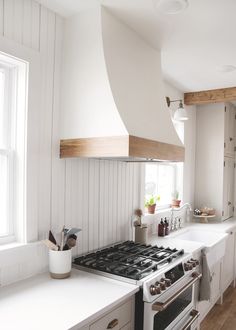 a kitchen with white walls and wooden floors