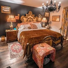 a bedroom with a large bed and chandelier