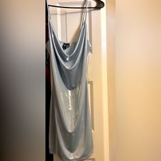 a dress hanging on a clothes rack in a closet