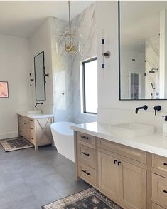 a large bathroom with two sinks and a bathtub