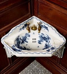 a white sink sitting on top of a wooden cabinet