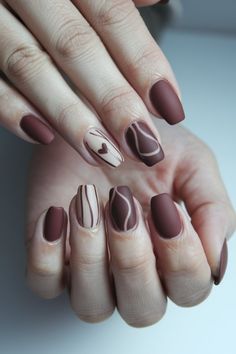 Get inspired by this trendy fall nail design featuring rich brown tones and elegant abstract accents. Perfect for the season, this matte nail set includes delicate line work and a cute heart detail, making it a stylish and fashionable choice for fall. Elevate your autumn look with this unique nail idea, combining warmth and sophistication in every detail Fall Nail Design, Mermaid Nail Art, Brown Nail, Fall Nail Ideas, Brown Nails Design, Heart Nail Designs, Matte Nail, Autumn Look