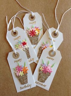 three birthday tags with flowers on them