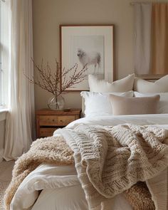 a bed with blankets and pillows in a bedroom