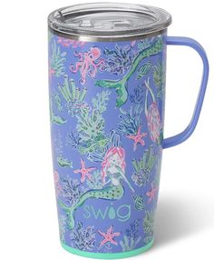 a purple and blue cup with mermaids on it