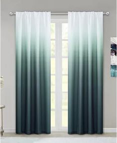 the curtains in this room are ombreed with blue and green tones, while the window