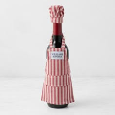 a red and white striped wine bottle cover