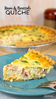 ham and broccoli quiche on a blue plate with a silver serving fork