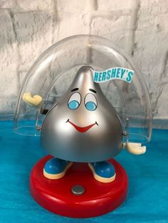 a silver and red toy on a blue surface