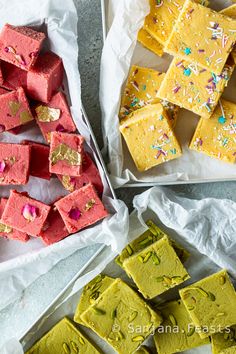 several different types of desserts on trays next to each other with confetti and sprinkles