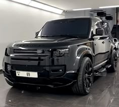 an suv is parked in a garage with other cars