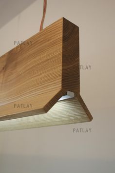 a wooden light hanging from the ceiling with words below it that say patlay, patlay and patlay