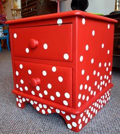 a red dresser with white polka dots on it