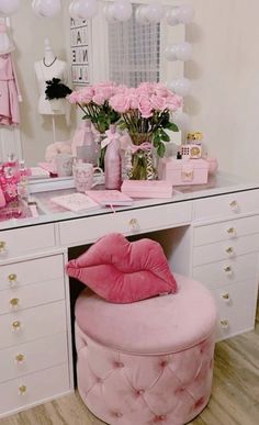 a vanity with pink furniture and flowers on it