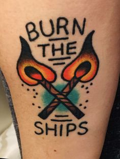 a tattoo that says burn the ships on it's leg with two crossed torches