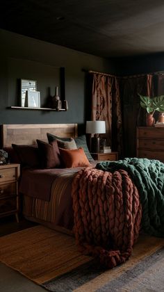 a bedroom with a large bed covered in blankets, pillows and throw blanket on the floor